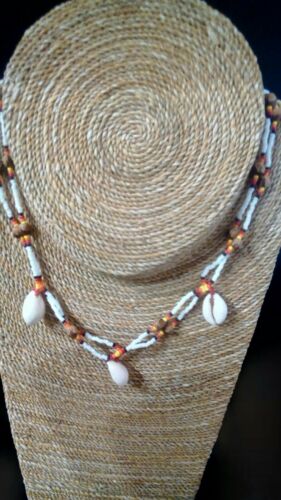 Beaded necklace made with conch shells and juniper seeds