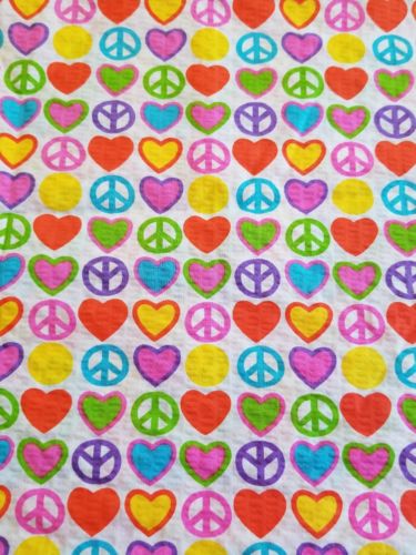 1 full yard of seersucker with hearts and peace signs, multicolored