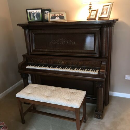 Oak Empire Revival style upright piano by the Beckwith Piano Company
