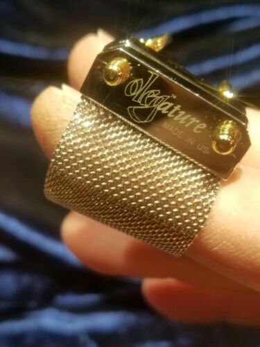 Rico clarinet ligature,  silver with gold screws. 