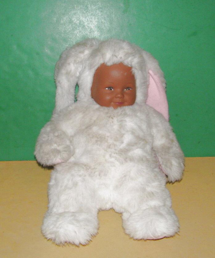 Brown Skinned Geddes Baby with White Bunny Outfit/Good Condition & cute.