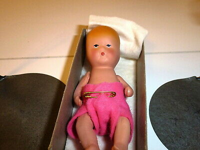 Miniature or doll house baby doll and two doll or display stands