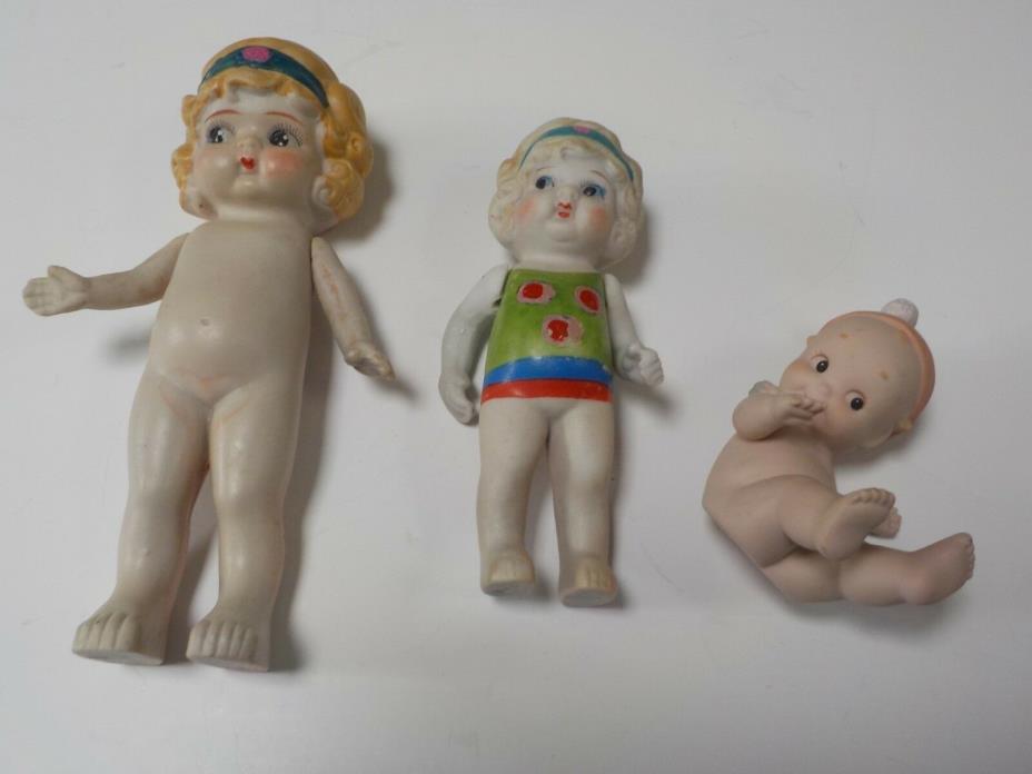 Set of two (2) vintage porcelain bisque dolls and one 1992 Enesco Kewpie baby