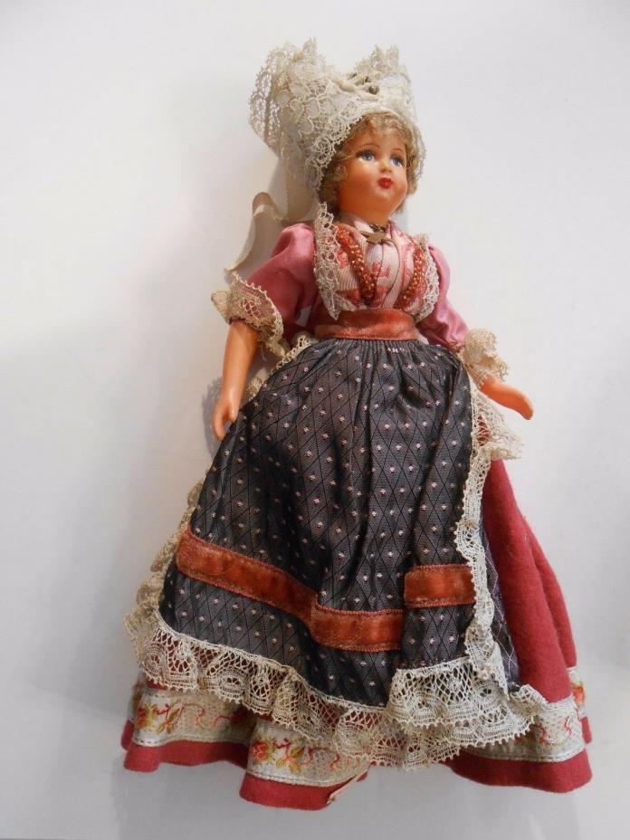 1950's era souvenir doll from Unknown Country. Wearing a cross around her neck.