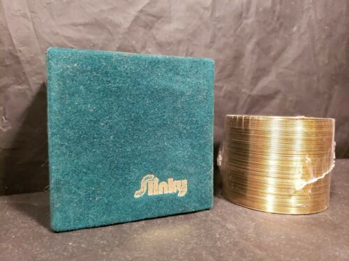 Vintage sealed nib Gold/brass anniversary Slinky Toy in Felt Box.