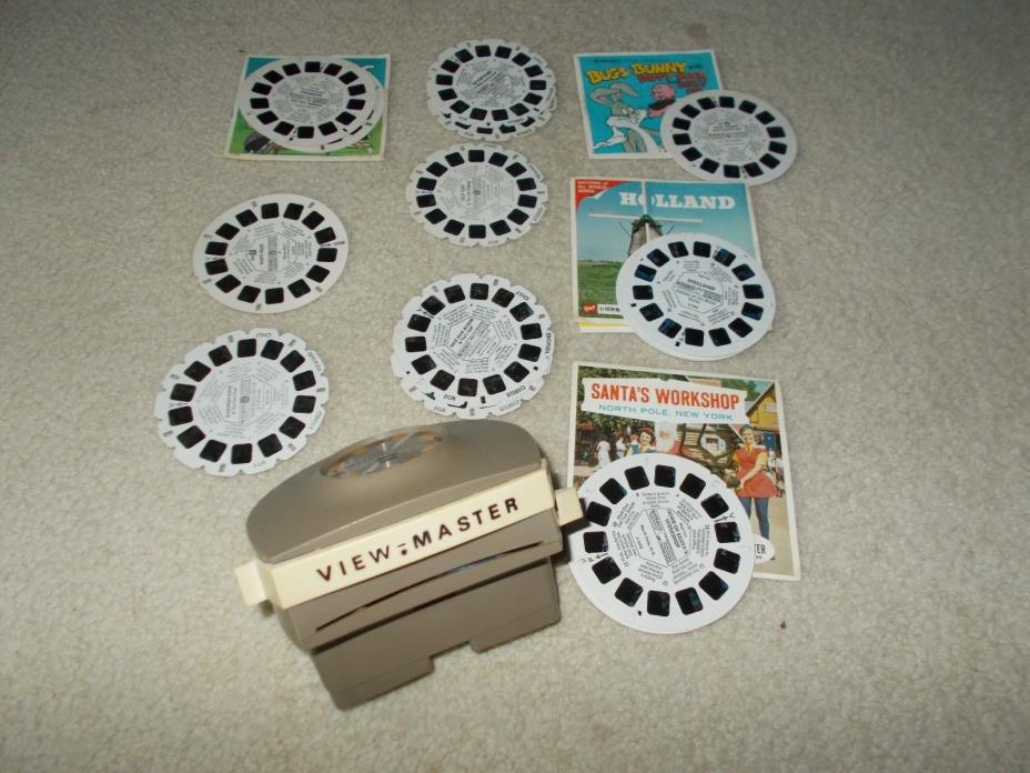 VIEW MASTER WITH 18 VARIOUS REELS SUCH AS DAFFY DUCK, PEANUTS, HUCKLEBERRY HOUND