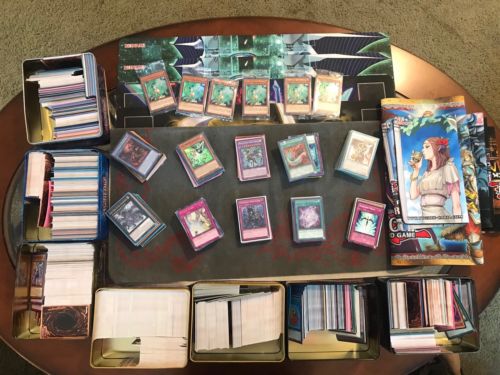 Yugioh! collection binders, tins, playmats, and a prize card