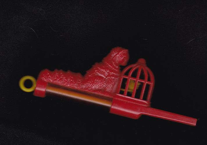 Vintage Mechanical slide whistle toy cat hovering over moving bird in cage