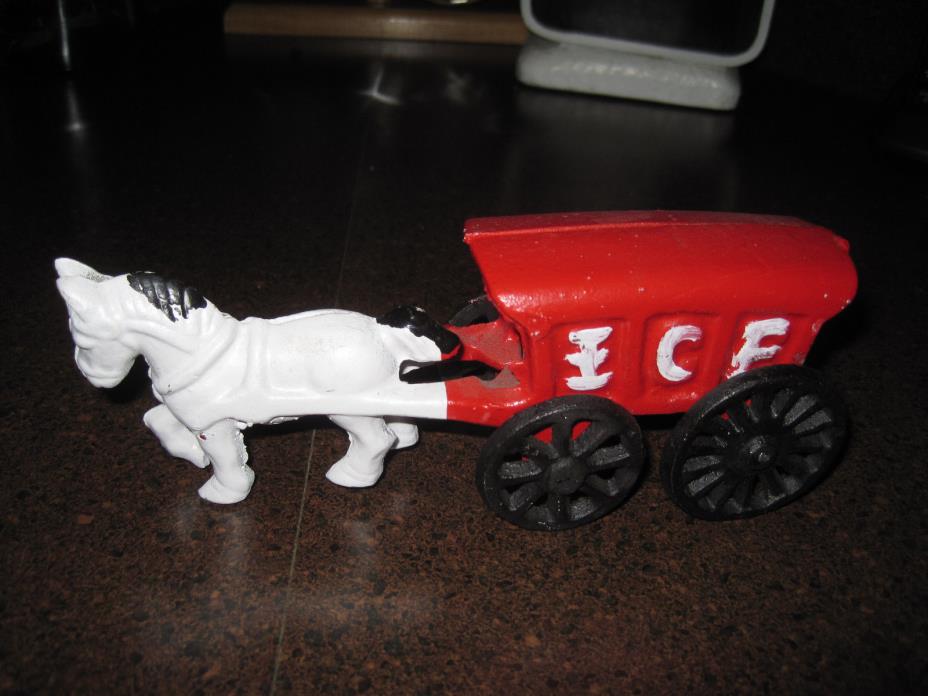 Reproduction cast iron horse pulling an ice cart
