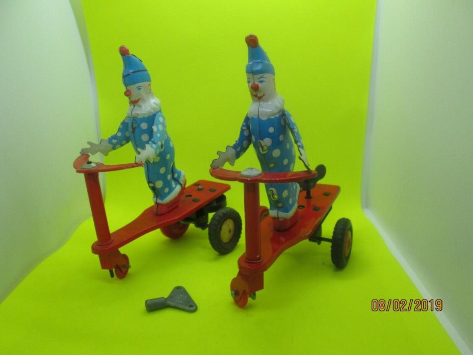 TWO TIN CLOWN ON SCOOTER WINDUP TOYS-WORKING