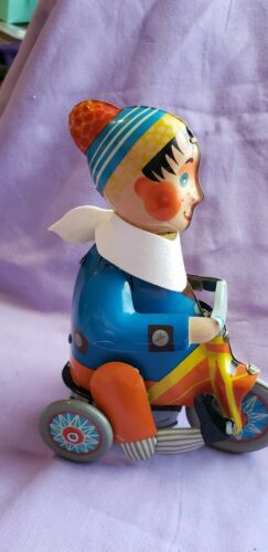 Vintage tin windup toy boy on tricycle
