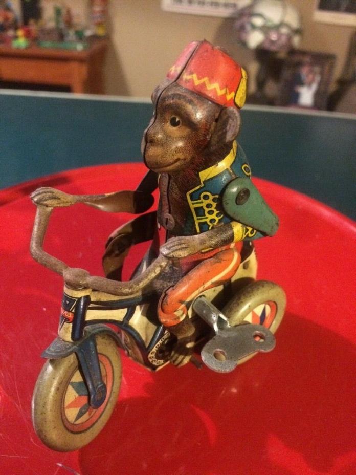 Antique 1940s tin wind up  monkey on tricycle toy