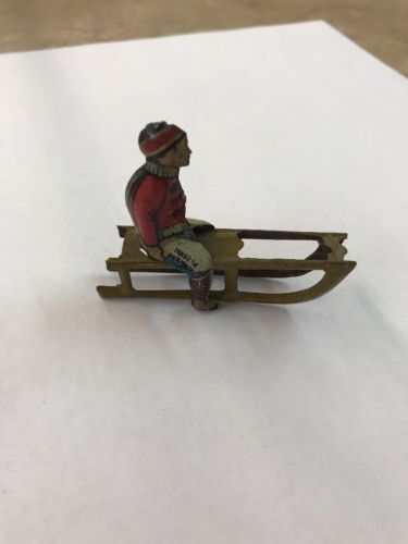 1930s GERMAN TIN PENNY TOY BOY ON SLED ANTIQUE TOY