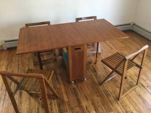 Danish Teak Drop Leaf Table with Four Hideaway Chairs.