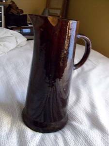 tall (12 inches tall) pitcher over 50 years old.. has chip on top ed