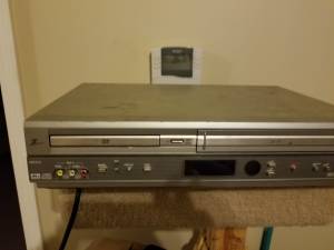Here a great deal VHS and DVD player with 100 movie vhs you pick the m (MOVING