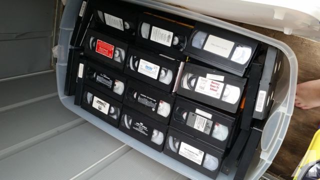 alot of vhs tapes and 5 or 6 dvds and a vhs rewinder