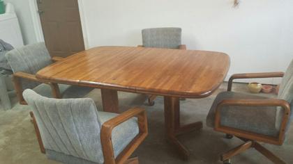 Solid Oak cutting board style Table with 4 swivel and rotating chairs.