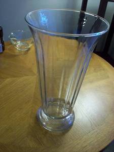 glass vase which is flaired top9 inches tall with fluted sides see pic