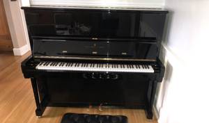 Steinway Model K upright piano with a black case and brass fittings (Columbus