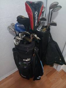 2 sets of golf clubs with bags.